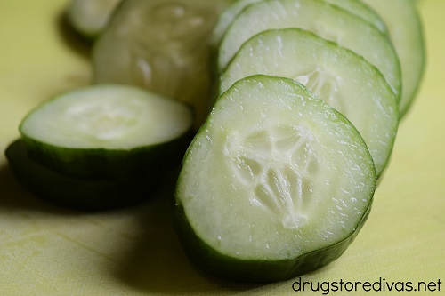Cucumber slices on a cutting board.
