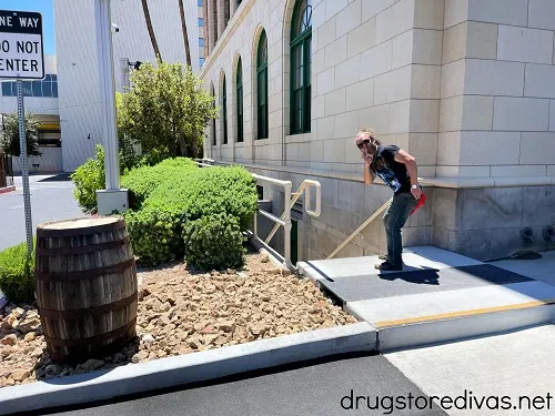 A man near a wooden barrel and a staircase behind the Mob Museum in Las Vegas.