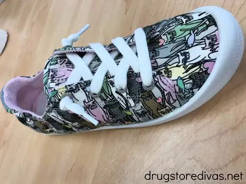 A pair of sneakers with cats on them.