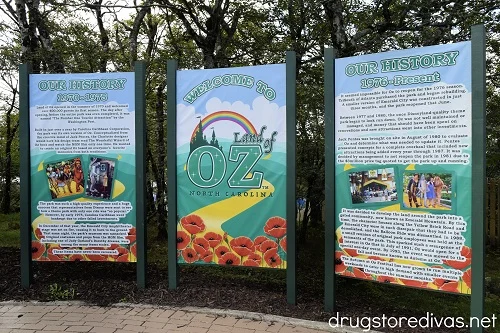 Three signs depicting the history of the Land of Oz theme park.