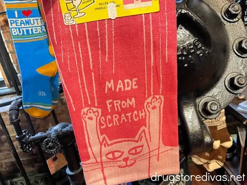 A red towel with a cat on it that says "Made From Scratch".