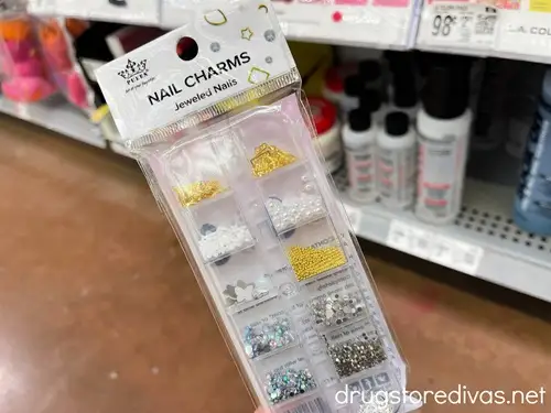 A box of nail charms in a store.