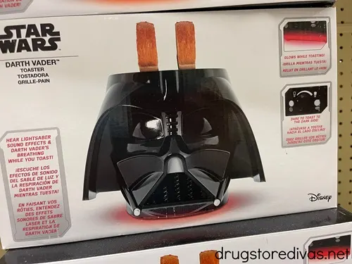 The box of a toaster that is shaped like Darth Vader from Star Wars' helmet.