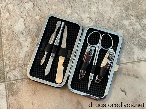 A travel manicure set that's open to show the nail tools inside.