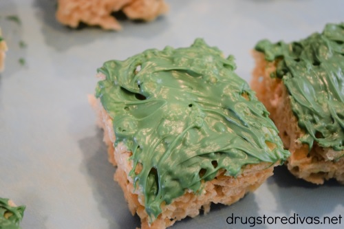 Rice Krispies Treats with green chocolate on them.