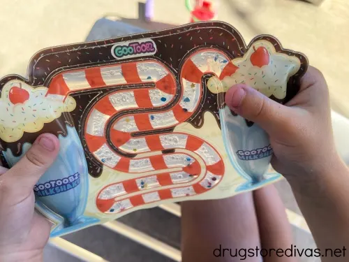 A GooToobz toy being held by a child's hands.