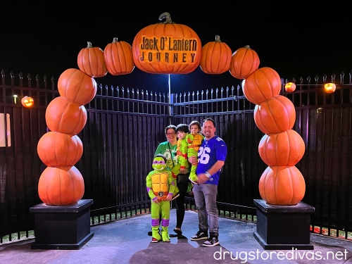 A family of five posing under a pumpkin arch at Pumpkin World in New York.