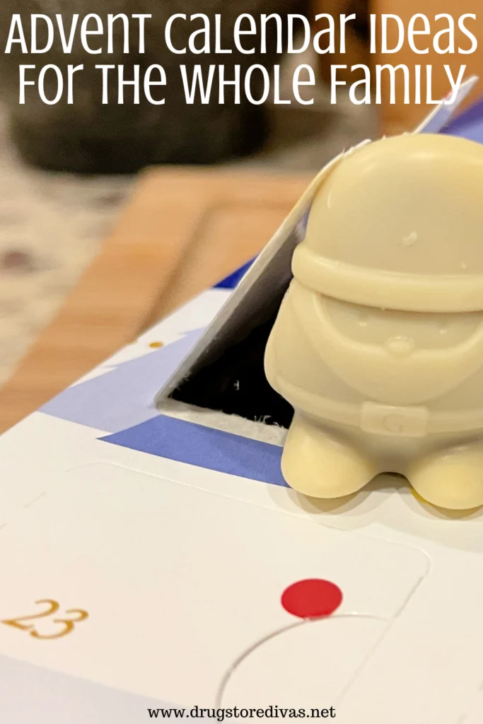 A chocolate Santa on top of an Advent calendar with the words "Advent Calendar Ideas For The Whole Family" digitally written on top.