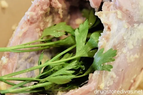 Fresh parsley in the cavity of a turkey breast.