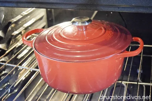 A red Dutch oven in the oven.