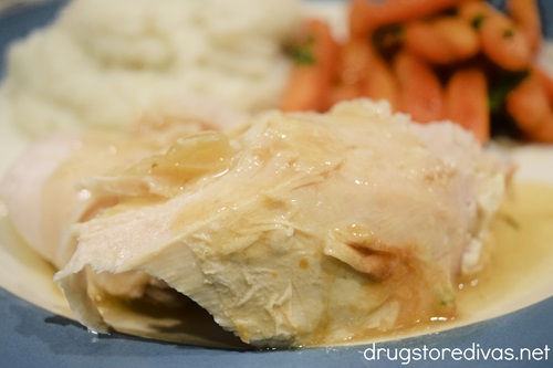 Turkey with gravy, mashed potatoes, and carrots on a plate.