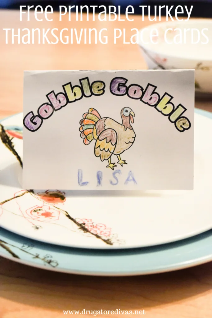 A table setting with a colored place card on top and the words "Free Printable Turkey Thanksgiving Place Card" digitally written on top.
