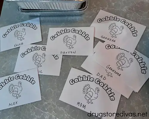 Eight Thanksgiving place cards printed out with names below them.