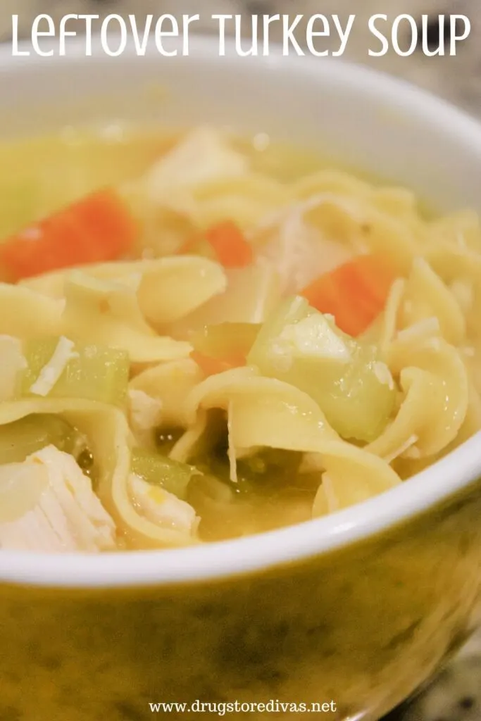 A bowl of soup with carrots, turkey, and egg noodles and the words "Leftover Turkey Soup" digitally written on top.
