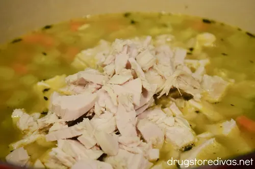 Chopped turkey meat on top of a soup.