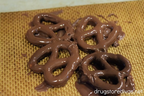 Four chocolate dipped mini pretzel twists in a circle.