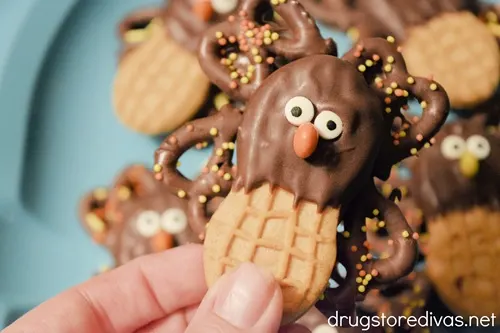 A ahnd holding a Nutter Butter Turkey Cookie.
