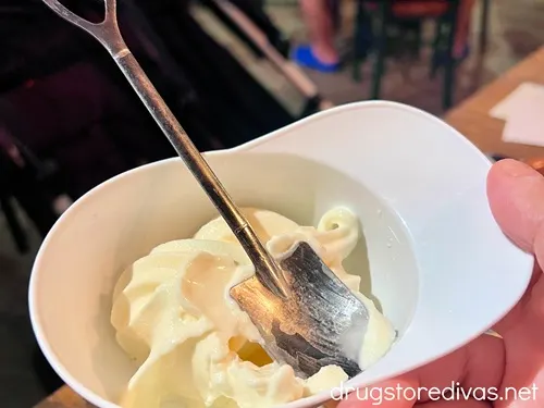 Vanilla soft serve ice cream in a plastic hat with a spoon shaped like a shovel in it, served at The Construction Zone restaurant in Kissimmee, Florida.