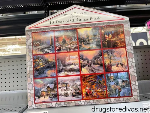 A Thomas Kinkade Puzzle Advent Calendar on a shelf.