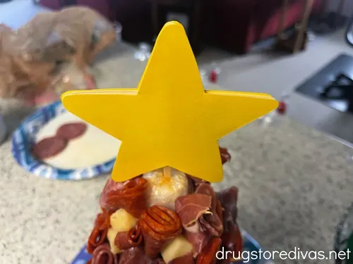 A yellow star on top of a charcuterie tree.