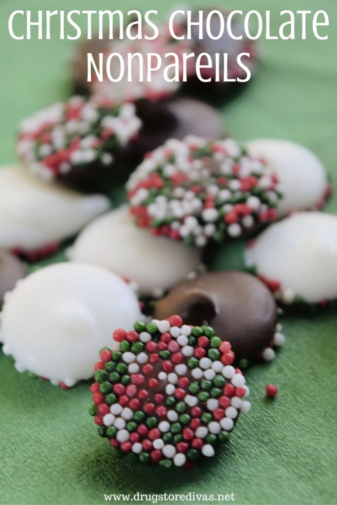 White and milk chocolate candies with red, white, and green sprinkles on the bottom on a green napkin and the words "Christmas Chocolate Nonpareils" digitally written on top.