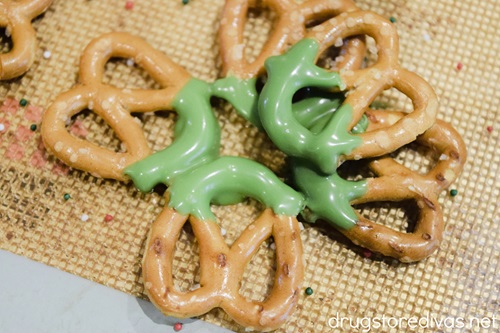 Five mini pretzels in two layers with green melted chocolate in the middle.
