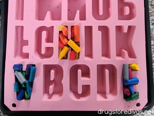 Pieces of crayons in an alphabet mold.