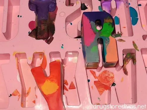 DIY crayon letters on top of an alphabet mold.