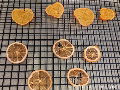 Dried orange slices on a wire baking rack.