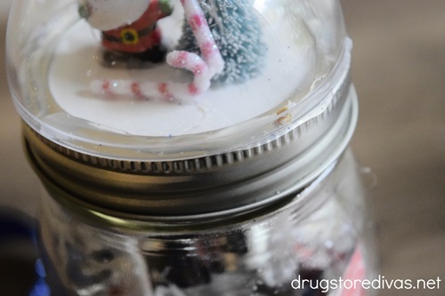 A snow globe lid twisted onto a mason jar.