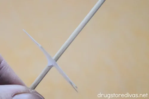 A thin piece of paper threaded onto a wooden stick.