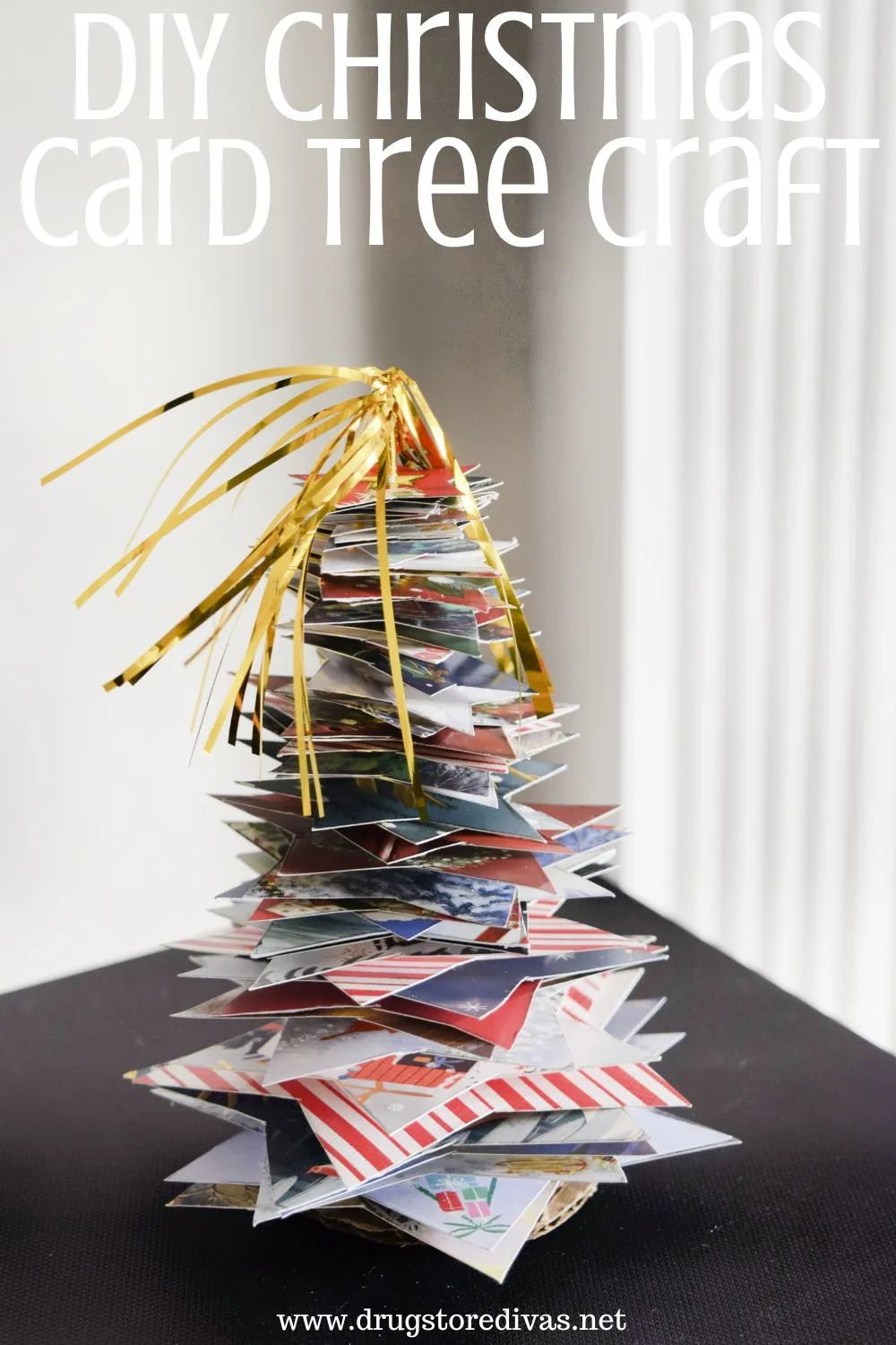 A Christmas tree decoration made from old cards with the words 