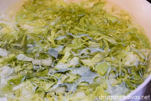 Shredded lettuce in a bowl of water.
