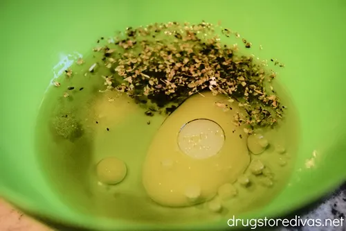 Oil and seasoning in a green bowl.