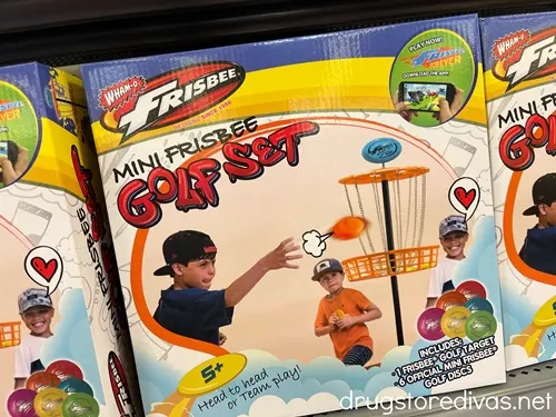 A Wham O Mini Frisbee Golf Set in a box on a shelf at the store.