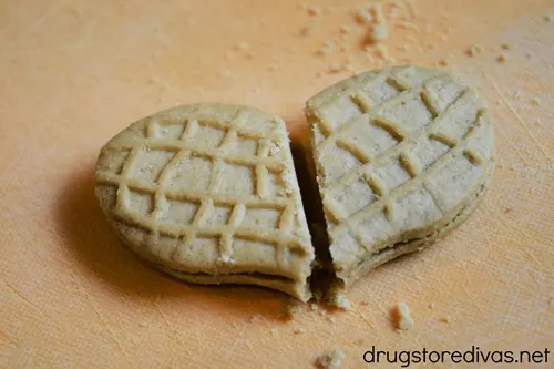Two halves of a Nutter Butter cookie together to form a heart.