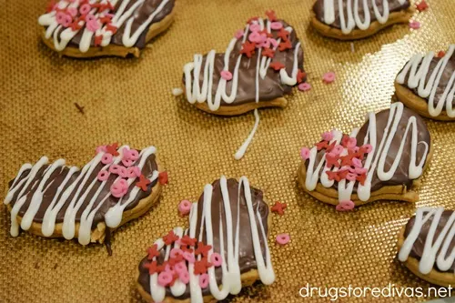 Decorated Nutter Butter Cookie Hearts on a baking sheet.
