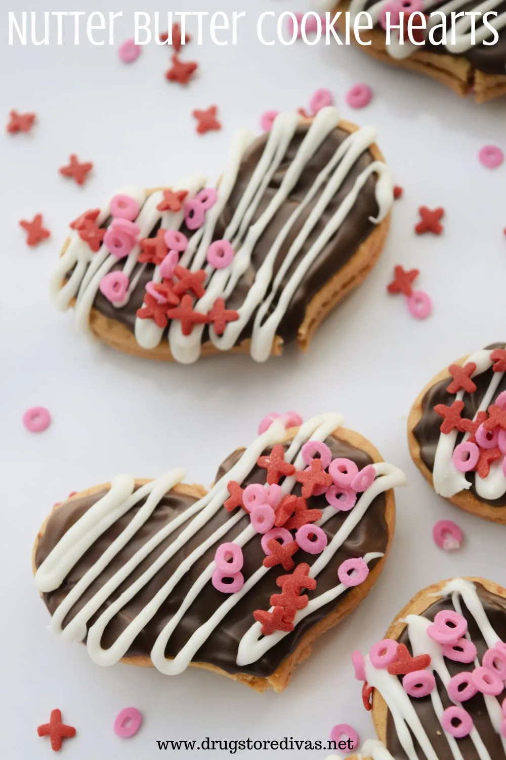 Heart cookies with chocolate, white zigzag chocolate, and XO sprinkles on them with the words 