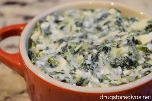 Spanakopita dip in a red mini Dutch oven.