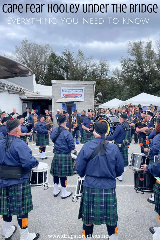 A pipe and drum band in front of Waterline Brewing Co. in Wilmington, NC with the words "Cape Fear Hooley Under The Bridge: Everything You Need To Know" digitally written on top.