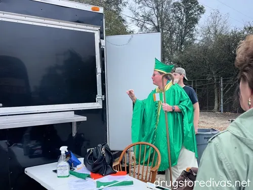 A bishop talking to the back of a food truck.
