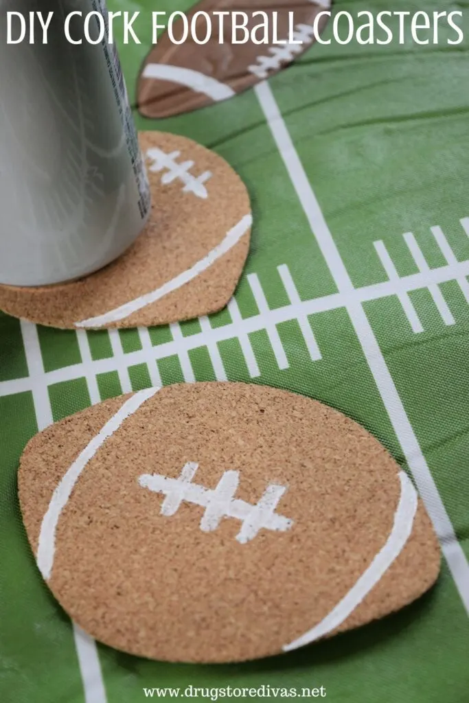 A can on a football coaster next to a football coaster on a football field tablecloth with the words "DIY Cork Football Coaster" digitally written on top.