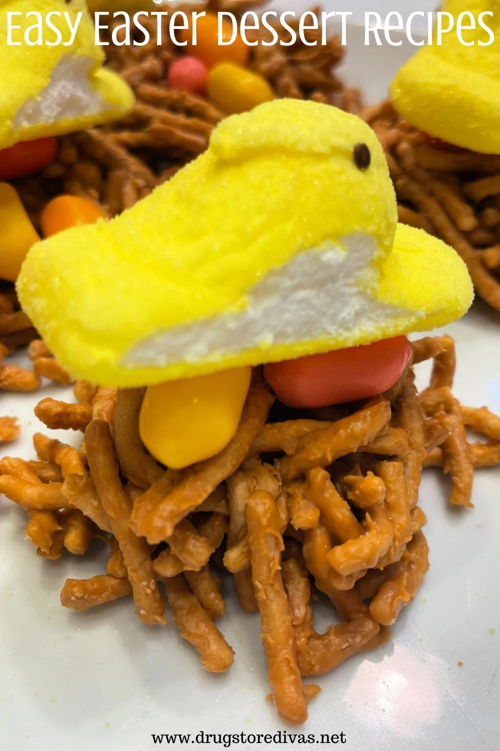 A birds nest made of pretzels with jelly beans and a yellow Peeps chick marshmallow on top with the words 