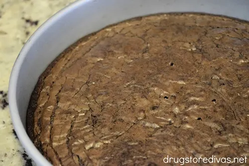 Baked brownies in a round cake pan.