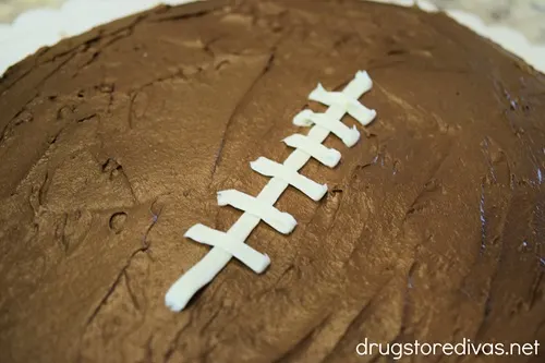 White football laces piped down the center of a football-shaped brownie.