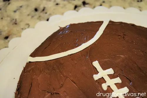 A white stripe on the side of a football-shaped brownie.