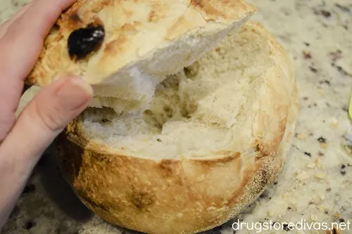 The top of a bread bowl being lifted.