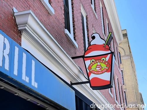An Italian ice-shaped sign off a building advertising Jeremiah's Italian Ice.