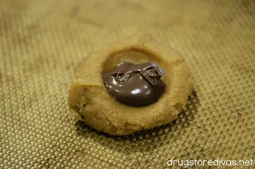 Nutella in the center of a well in a dough ball.