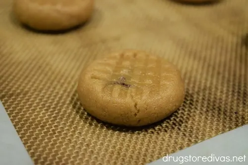 A peanut butter cookie with hash marks on top.